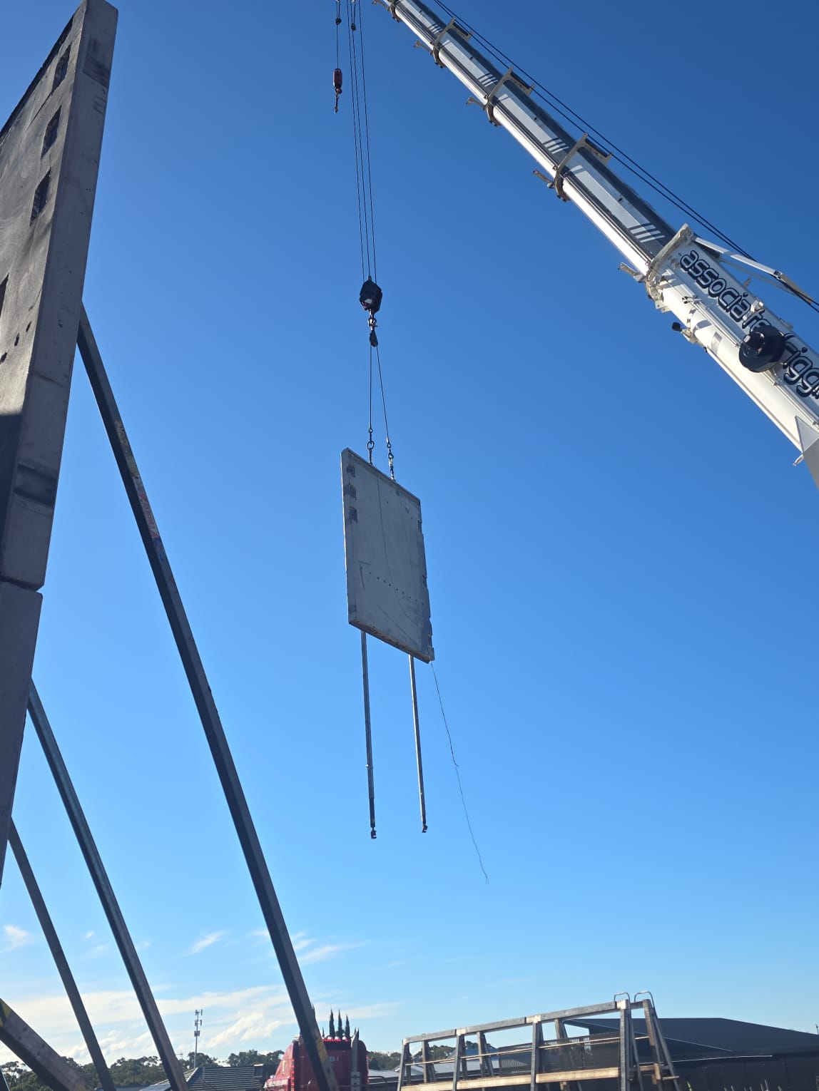 Precast concrete panel being craned into place